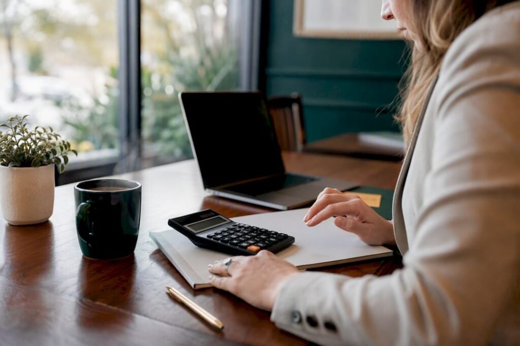 Payroll checklist and calculator on desk