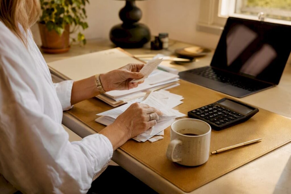 Startup founder's hands reconciling financial receipts