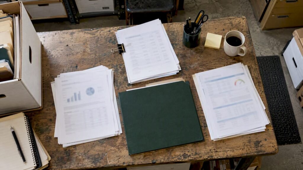Loan preparation papers beside a green folder